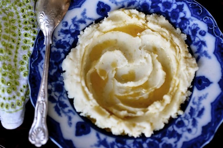 Mashed Potatoes with Olive Oil swirled on a blue plate