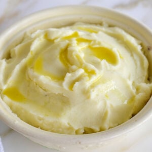 Mashed potatoes with olive oil on top and in a little glass dish on the side