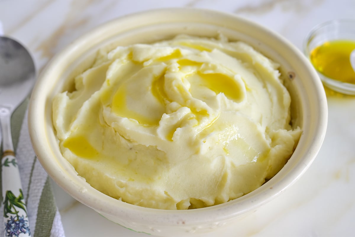 Mashed potatoes with olive oil on top and in a little glass dish on the side