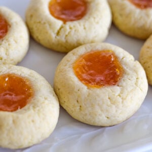 Thumbprint cookies with apricot jam on a white plate