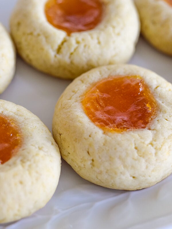 Thumbprint cookies with apricot jam on a white plate