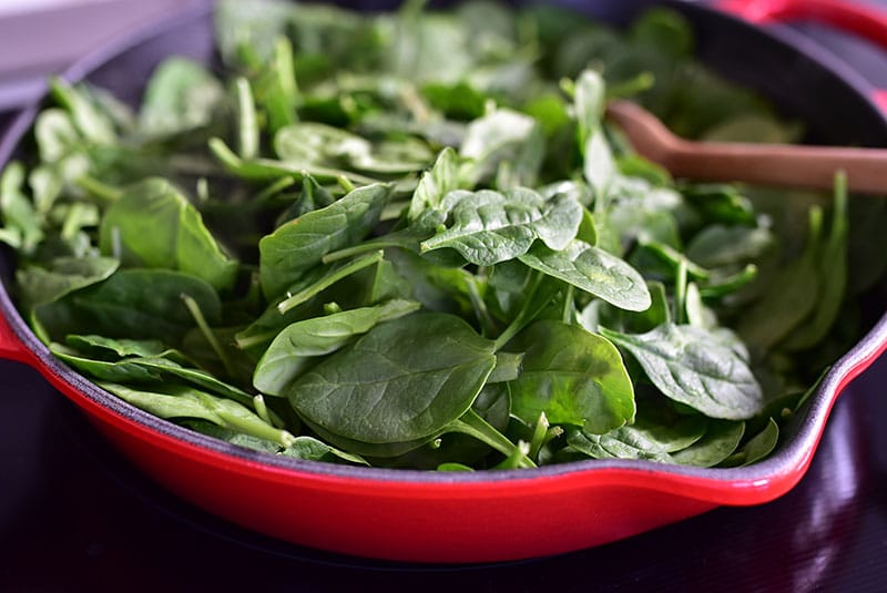 Baby spinach added to the skillet.