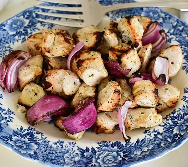 Grilled marinated chicken kebabs on a vintage blue platter, from Maureen Abood.