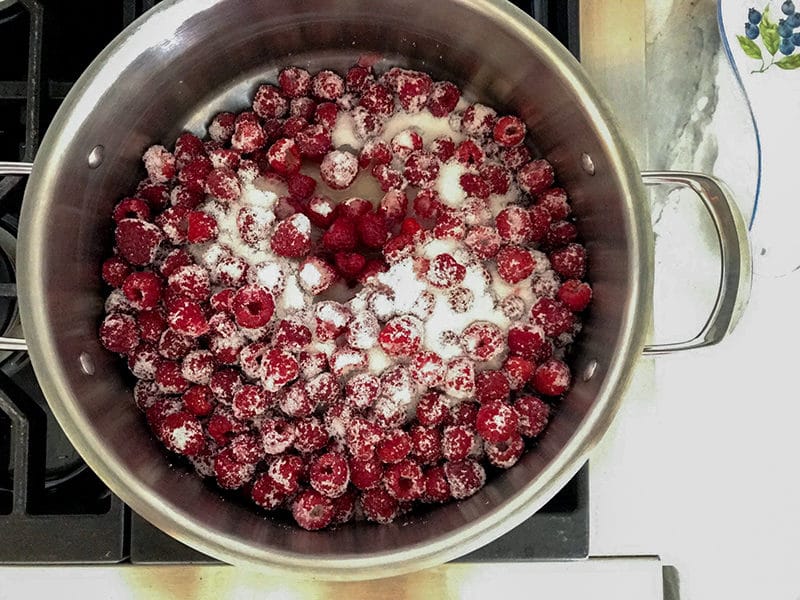 A pot on the stove filled with raspberries and sugar, Maureen Abood