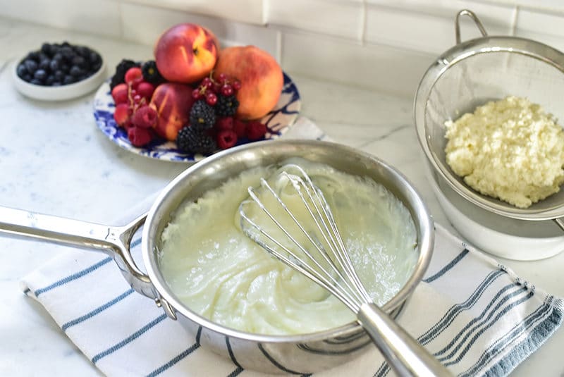 Cream and clotted cream in a bowl, with fruit, for the ashta recipe from Maureen Abood