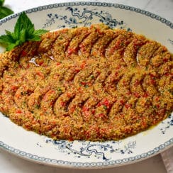 Tomato kibbeh on a blue and white oval platter, garnished with fresh mint, Maureen Abood.