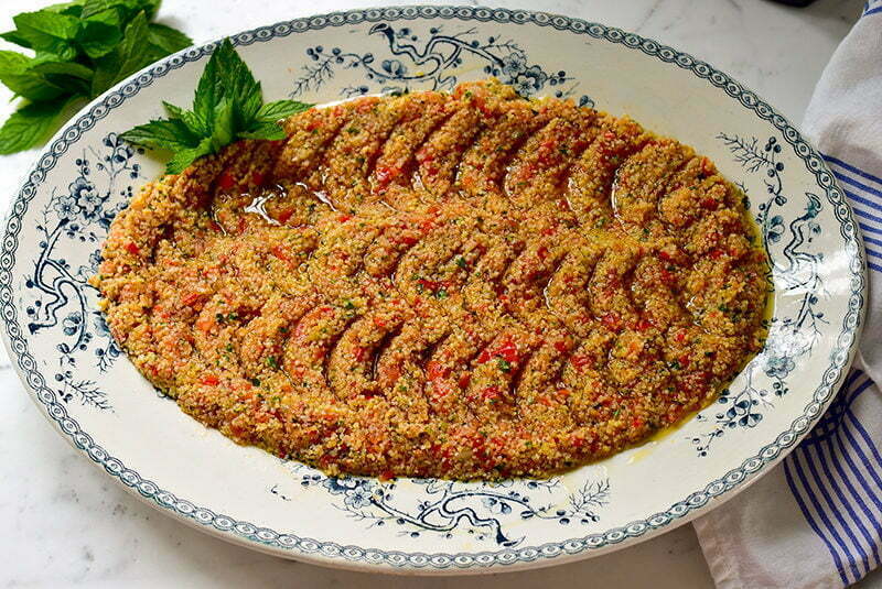 Tomato kibbeh on a blue and white oval platter, garnished with fresh mint, Maureen Abood.