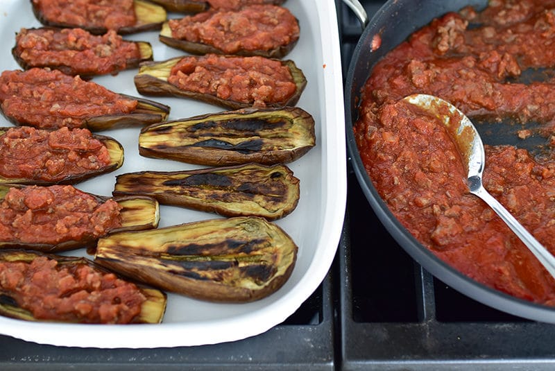 Eggplant boats in a white casserole filled with tomato meat sauce, Maureen Abood