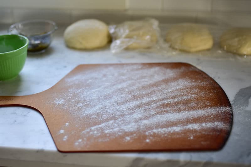 Pizza peel dusted with flour for za'atar flatbread