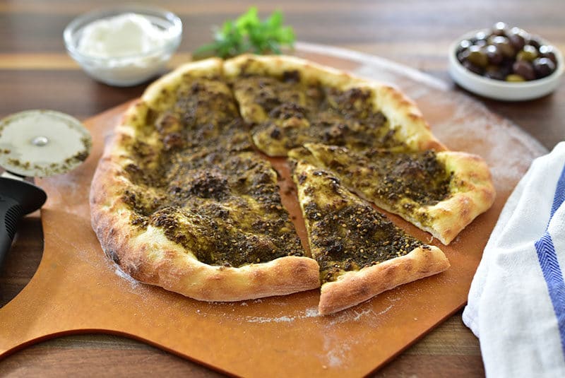 Zaatar flatbread on a pizza peel