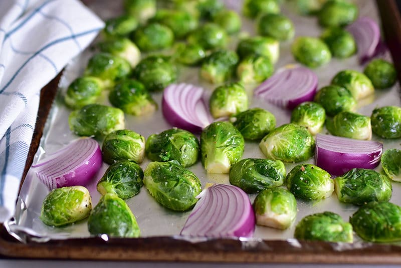 Brussels sprouts and onions on a sheet pan before baking, MaureenAbood.com