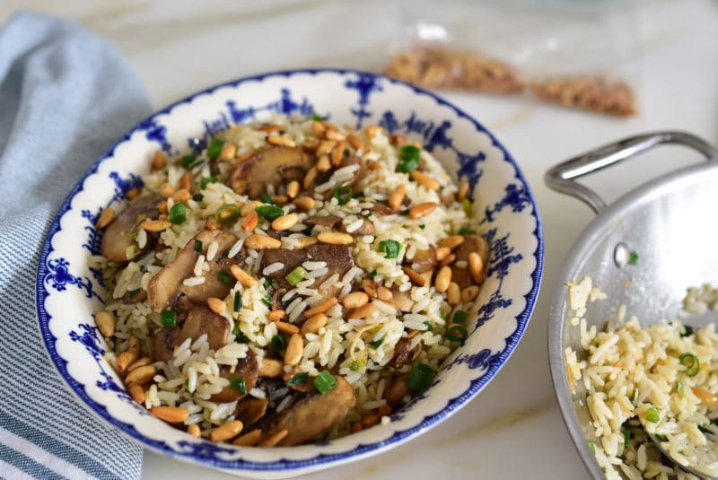 Mushroom and cinnamon rice garnished with toasted pine nuts