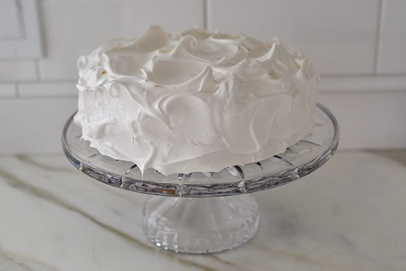 Meringue frosted cake on a crystal stand, Maureen Abood
