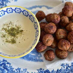 Kibbeh Bites with tahini dipping sauce on a blue plate