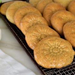 Date filled molded kaik cookies stacked on a paltter