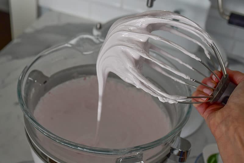 Glossy pink marshmallow on the KitchenAid mixer whisk