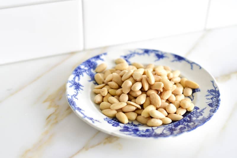 Blanched almonds on a vintage blue and white plate
