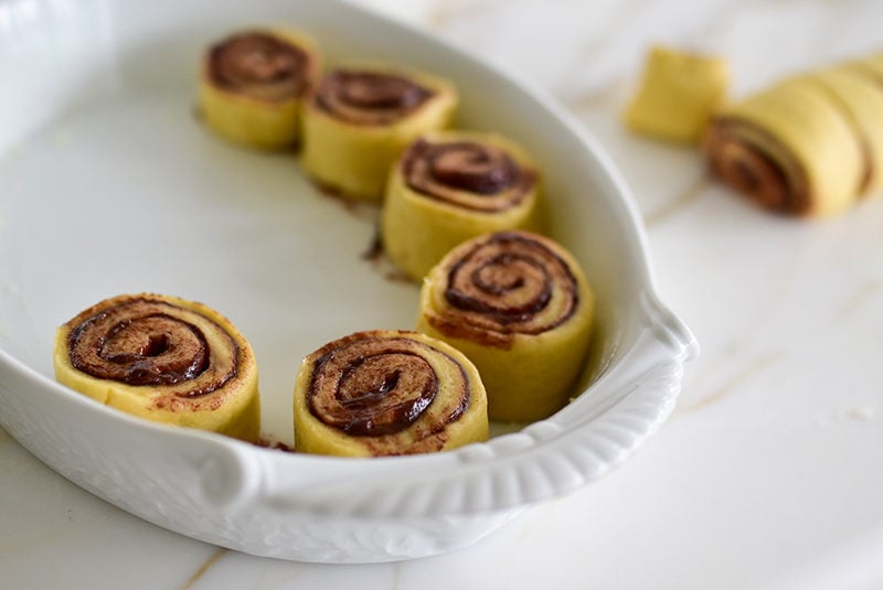 Cut dough rolls in the baking dish for chocolate tahini breakfast rolls