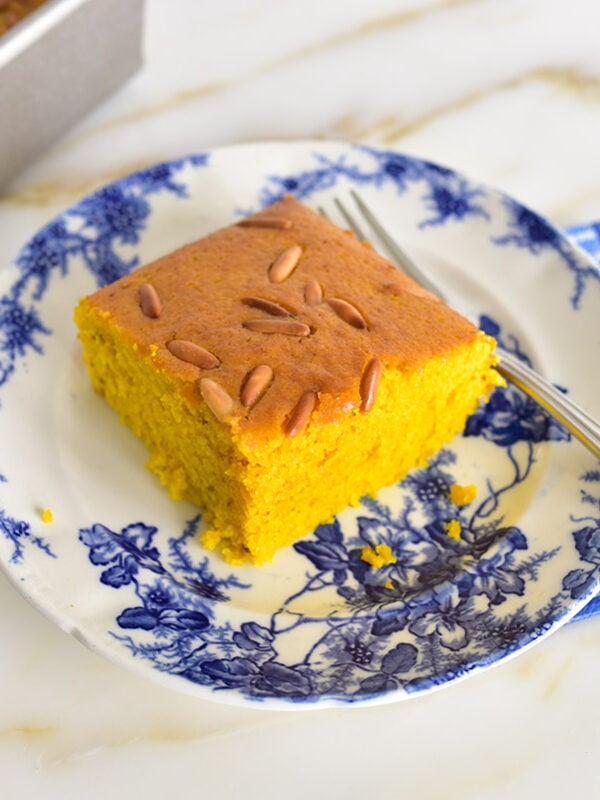 Square of sfouf cake on a blue and white plate