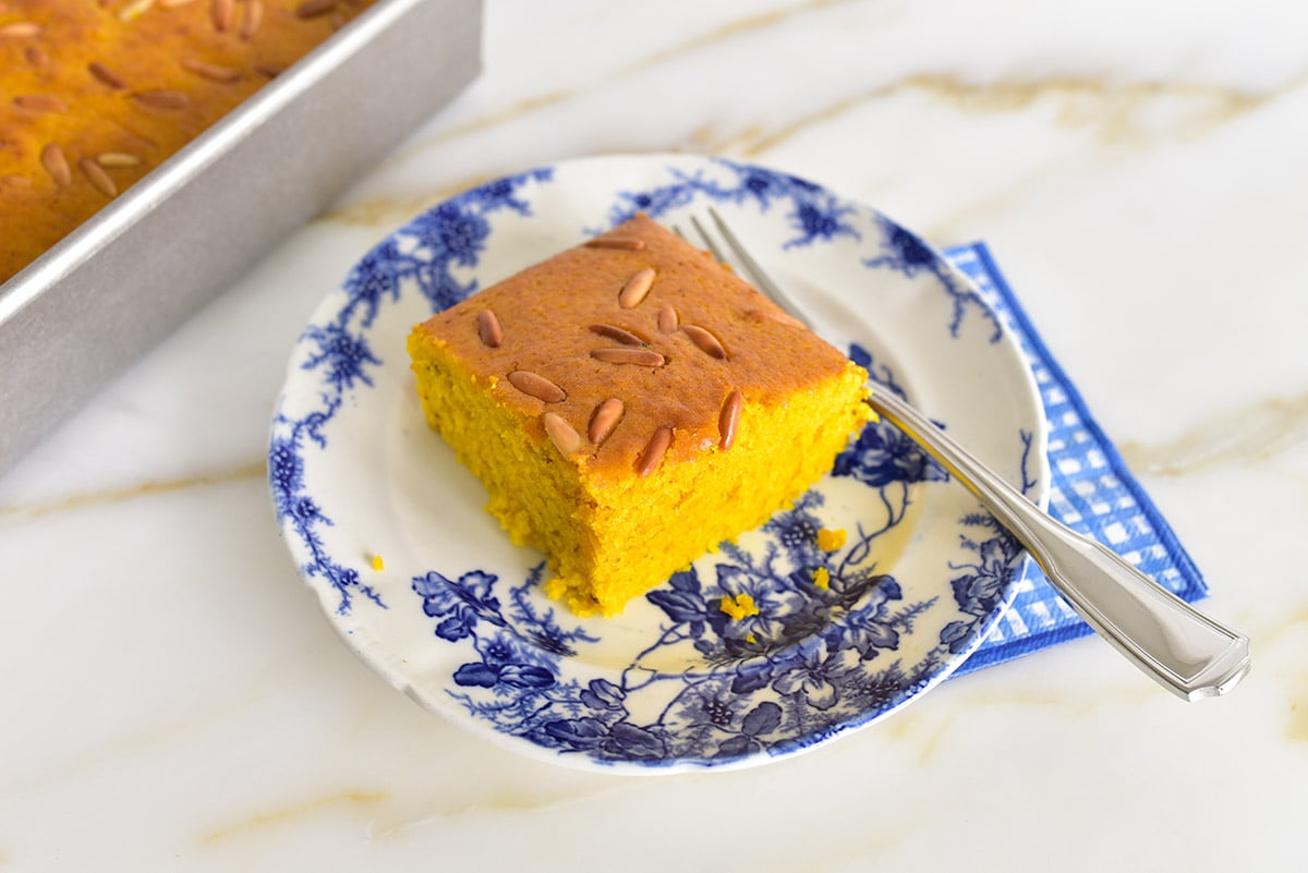 Square of sfouf cake on a blue and white plate