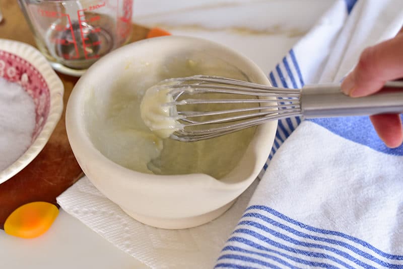 Toum spread being whisked together in a mortar.