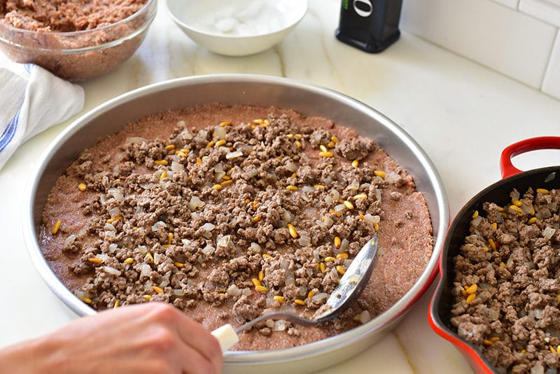 https://maureenabood.com/wp-content/uploads/2018/05/Filling-the-kibbeh-sanieh-Maureen-Abood-800x535.jpg