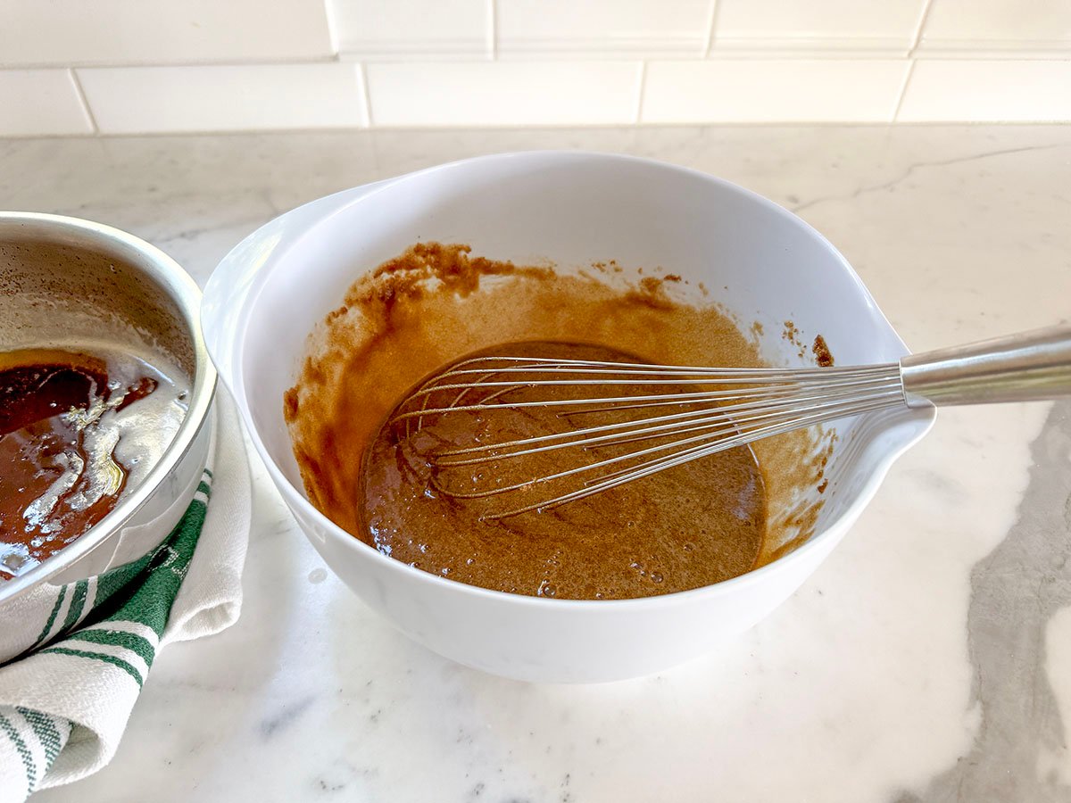 batter in a white bowl with a whisk