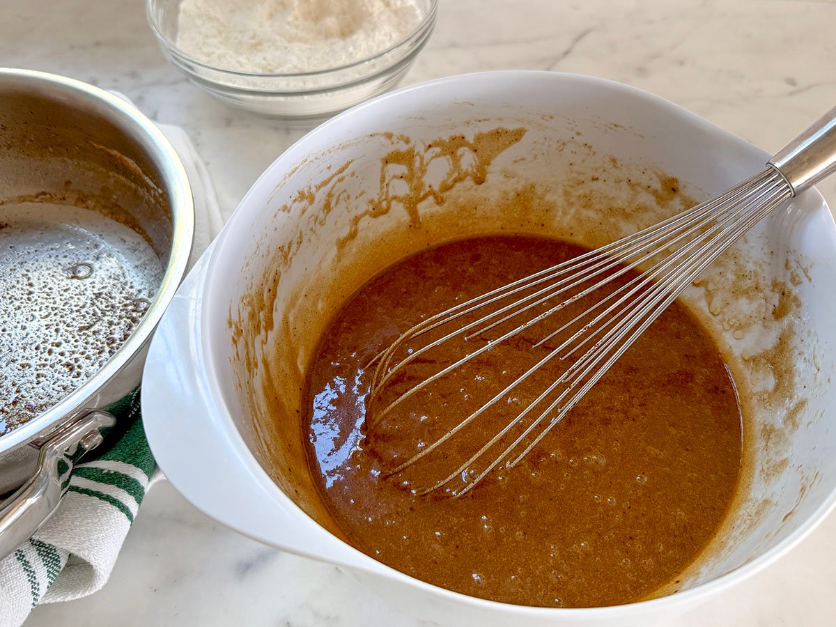batter in a white bowl on a marble countertop