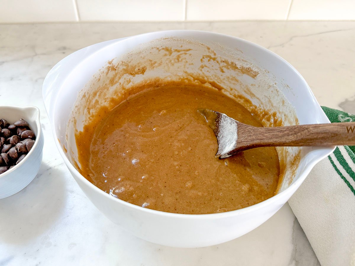 blondie bar batter with a wooden spoon in a white bowl