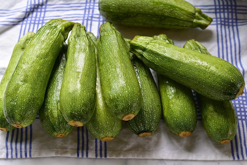 kousa squash on a blue and white towel for coring