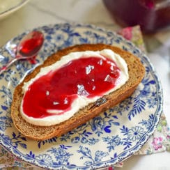 Raspberry jelly on toast on a blue plate