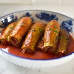 Stuffed squash with tomato sauce in a blue bowl