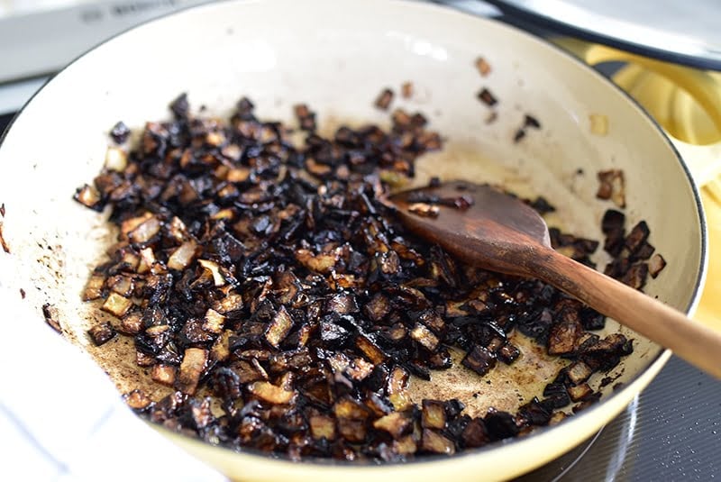 Charred onions on the stove for mujadara