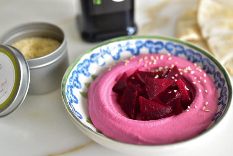 Red beet hummus with beets and sesame seeds in a bowl