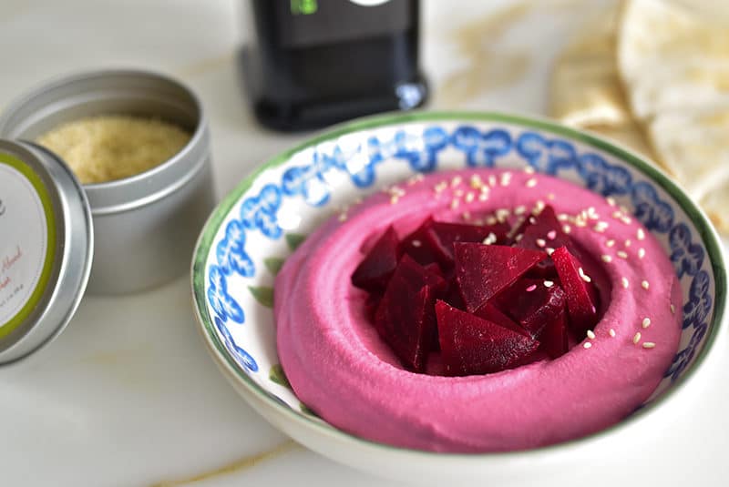 Red beet hummus with beets and sesame seeds in a bowl