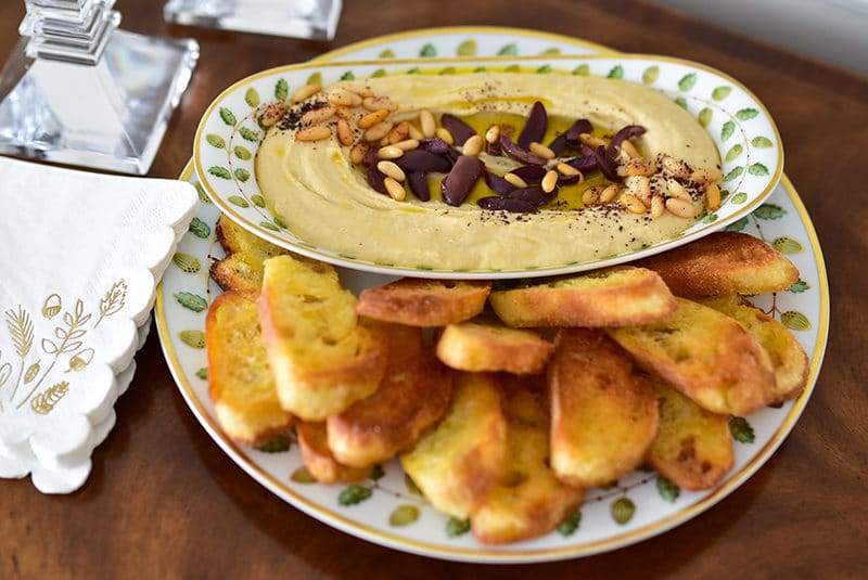 Hummus with olives in Bernardaud china, in the dining room
