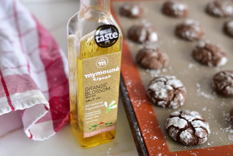 Chocolate crinkle cookies with bottle of Mymoune orange blossom water