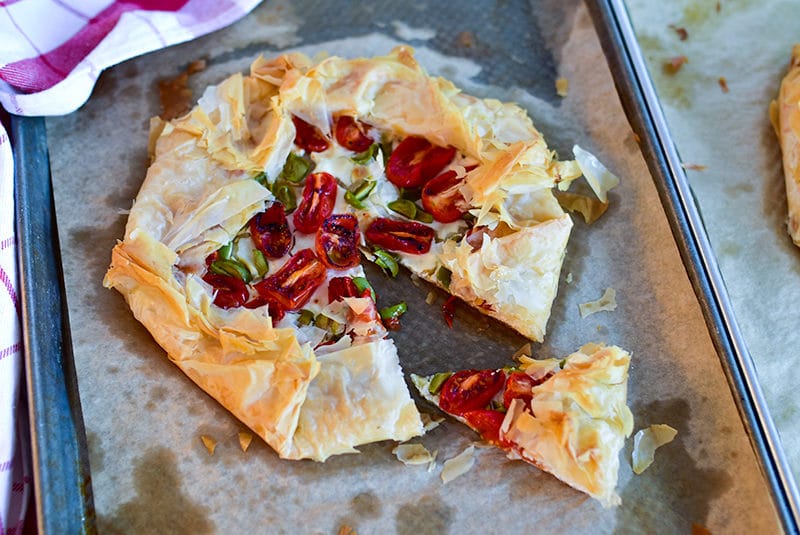 Savory Phyllo Galette on a sheet pan with a slice cut