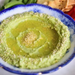 Avocado tahini dip with sesame seeds and crudite