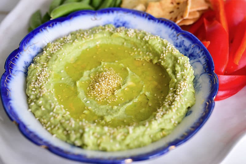 Avocado tahini dip with sesame seeds and crudite