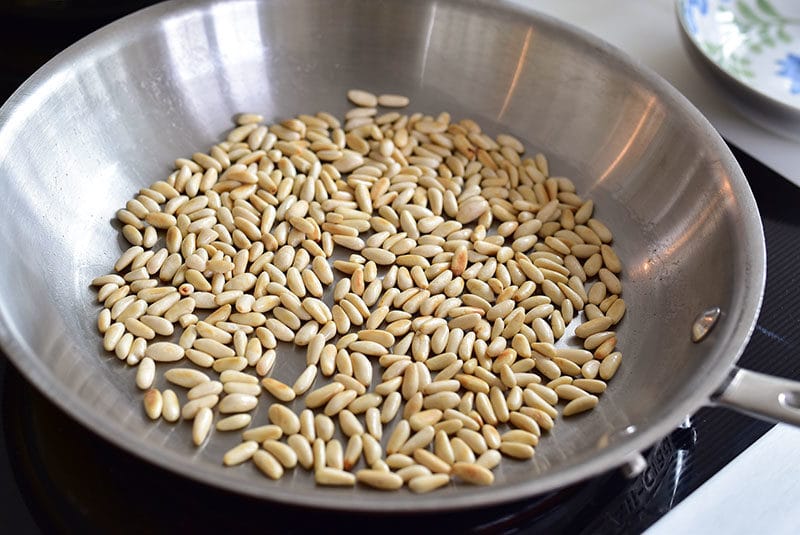 Pine nuts toasting in a dry pan