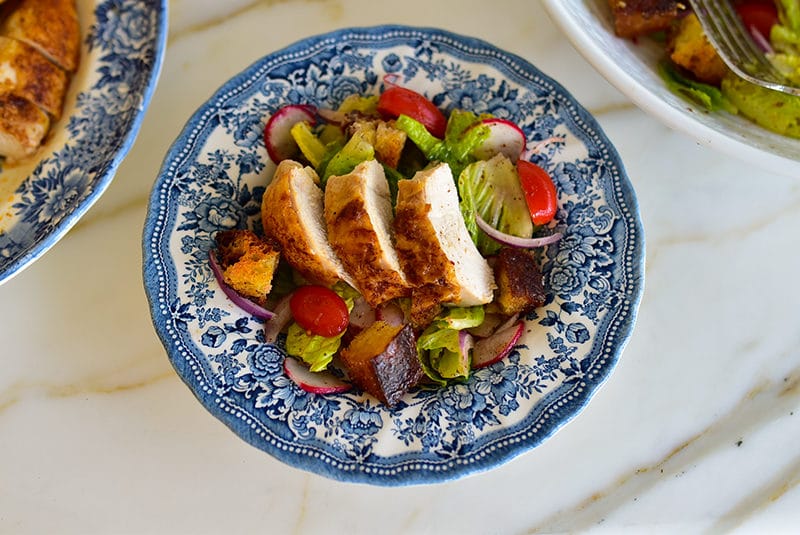 Fattoush topped with roasted chicken and croutons