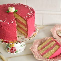 Raspberry buttercream cake slice on a pink plate