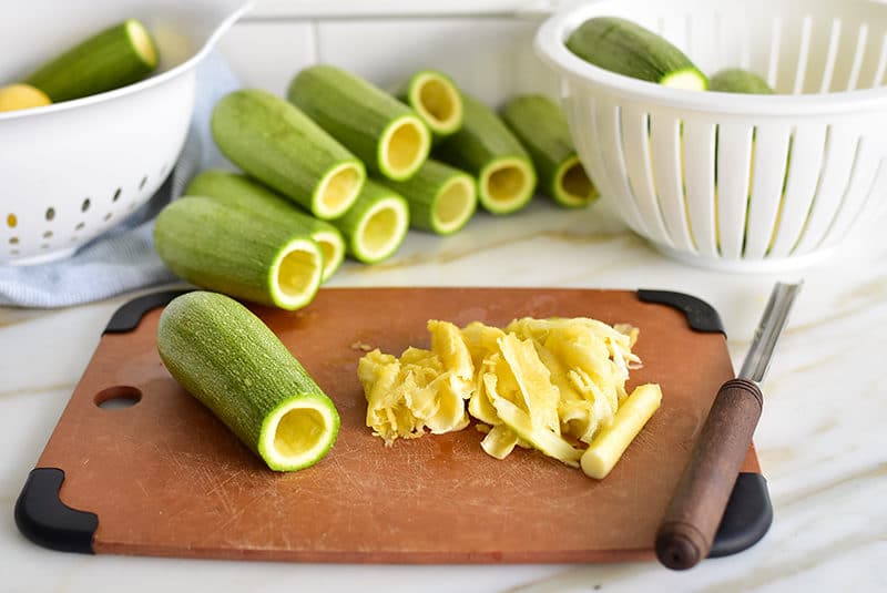 Lebanese koosa squash with corer and cores on a board