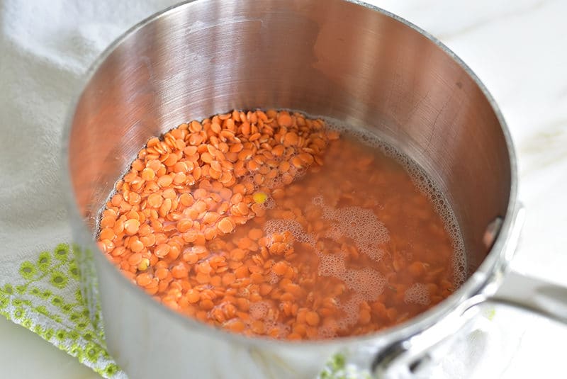 Parcooked red lentils in a saucepan
