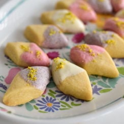 Shortbread dipped in white chocolate on a platter