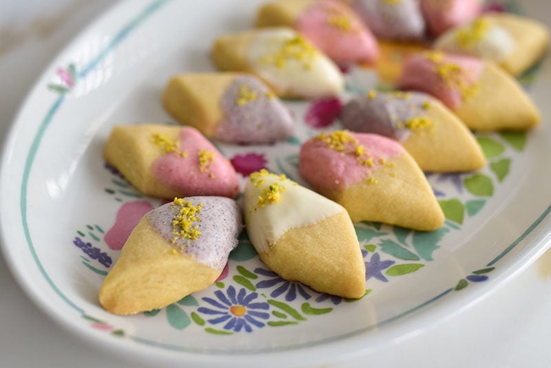 Shortbread dipped in white chocolate on a platter