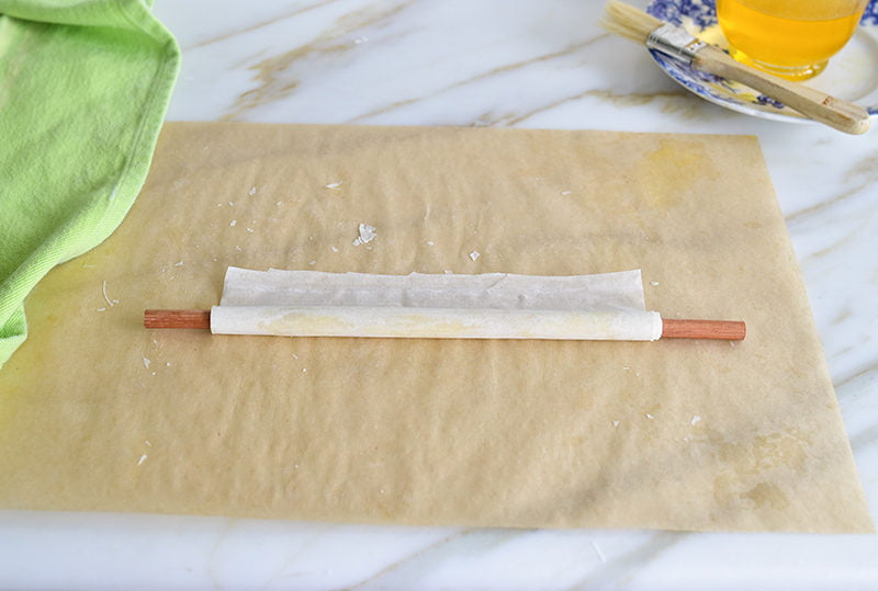 Phyllo rolled up on a dowel for baklava nests
