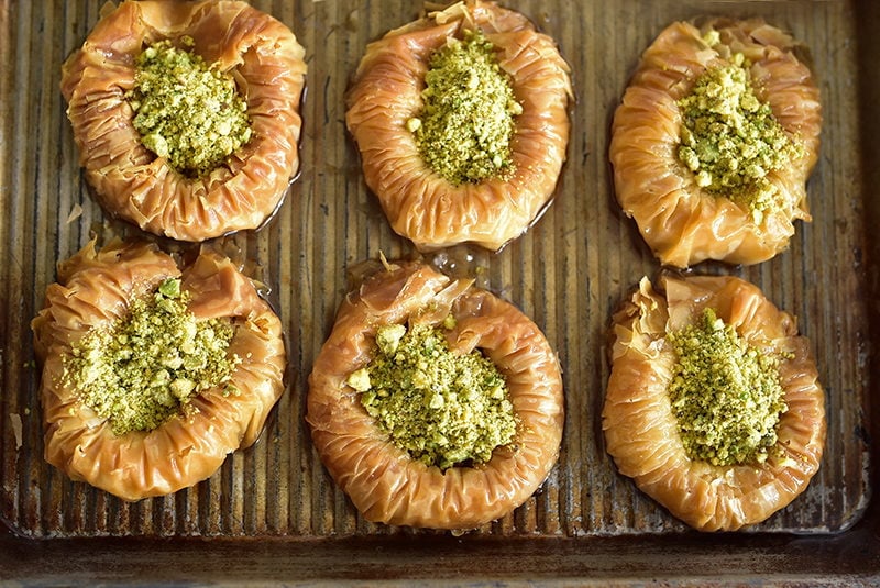 Pistachio baklava nests on a sheet pan