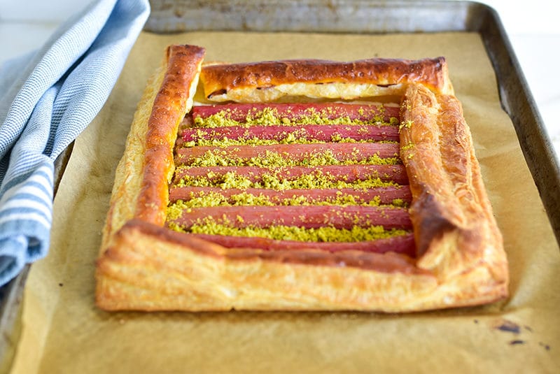 Rhubarb tart with pistachios on a sheet pan